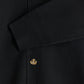 Close-up of the Drôle de Monsieur LE Cardigan Blk, featuring elegant embroidery, three beige buttons, and a diagonally folded sleeve.