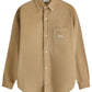 The Drôle de Monsieur Perm-SH172-CO156-BG La Chemise Beige features a tan corduroy long-sleeve design, button-down front, and a single chest pocket with "Only" in Drole embroidery.