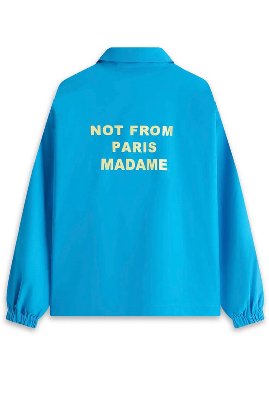 Blue DROLE DE MONSIEUR water-repellent jacket with the printed slogan "not from paris madame" on the back.