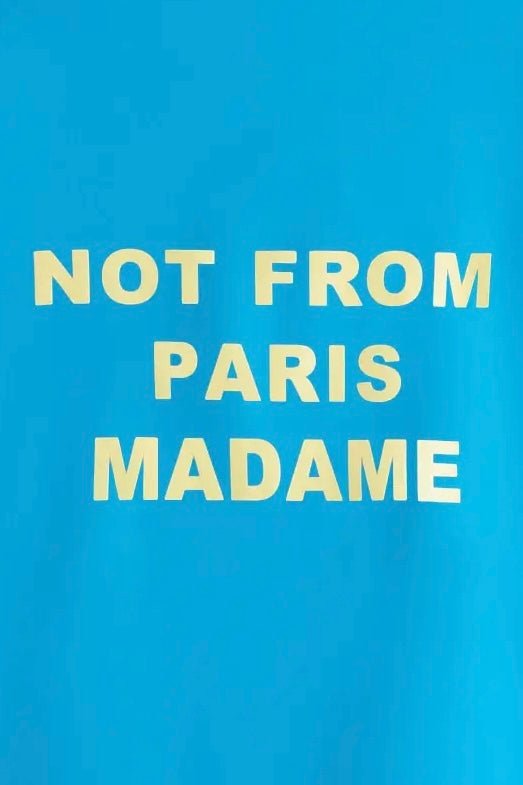 Text on a blue background reads "not from paris madame" on a DROLE DE MONSIEUR SHIRT D-JT174-PL007-BE LA VESTE SLOGAN water-repellent jacket.