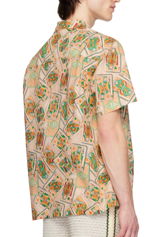 A person viewed from the side, wearing a DROLE DE MONSIEUR SHIRT D-SH158-LI002 LA CHEMISE JEU DE CARTES PC shirt with geometric and abstract designs, made in Portugal.