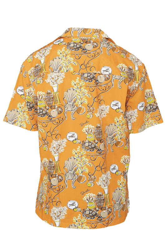A yellow open collar, short-sleeved DROLE DE MONSIEUR shirt with a floral and coffee cup print pattern.