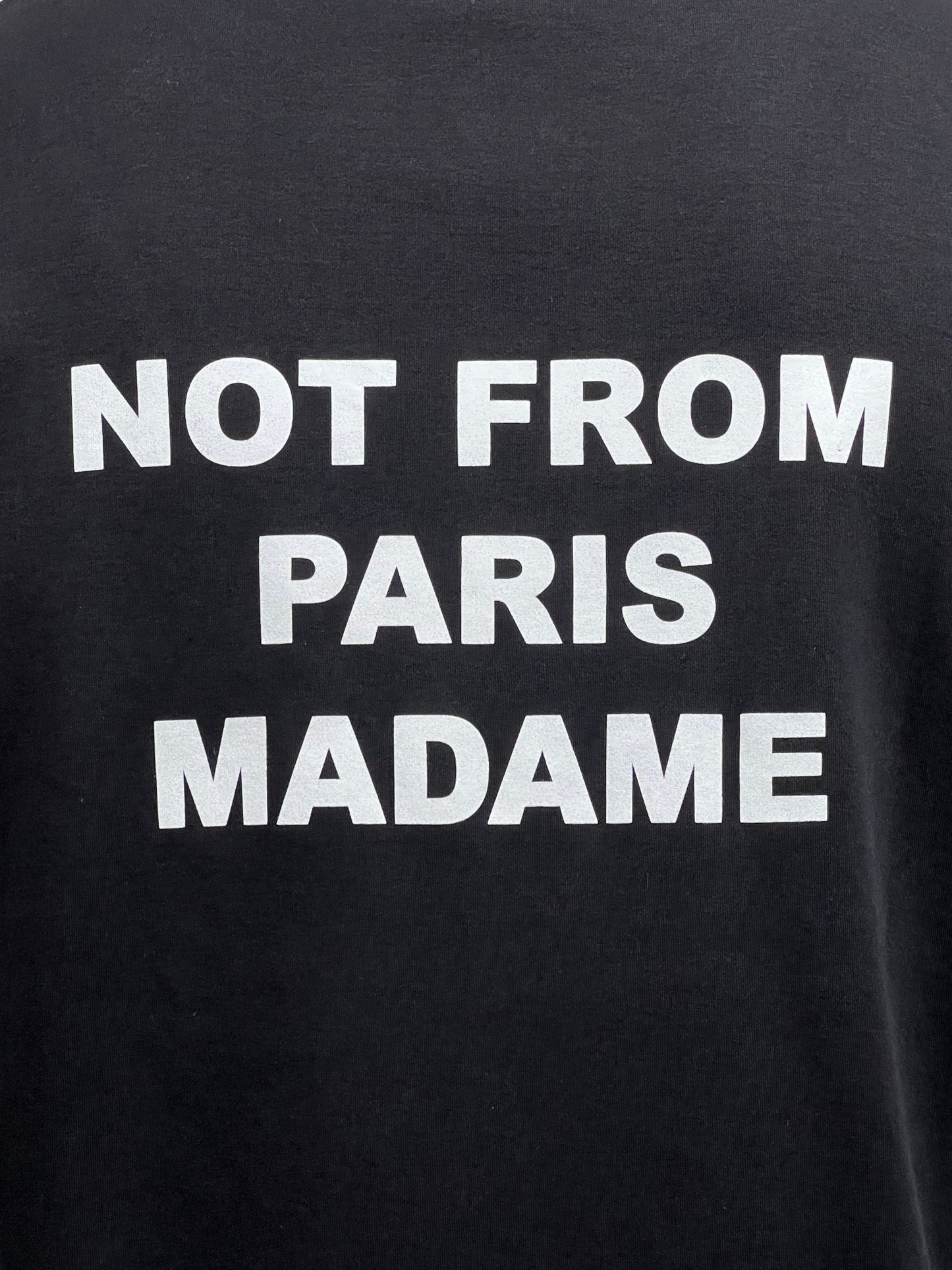 A black, 100% cotton DROLE DE MONSIEUR TS203-CO002-BL LE T-SHIRT SLOGAN BLACK with white text that proudly reads "NOT FROM PARIS MADAME.