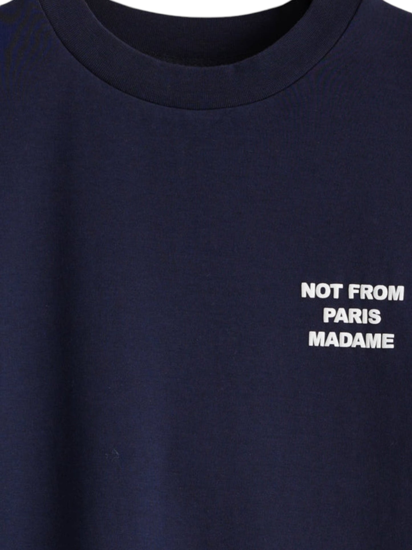 A detailed look at Drôle de Monsieur's TS203-Co002-NY Le T-Shirt Slogan Navy, this navy blue t-shirt by Drôle de Monsieur is made from soft cotton interlock fabric and showcases the statement "NOT FROM PARIS MADAME" in white text on the chest, blending comfort with style.