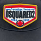 The DSQUARED2 BCM0763 Logo Baseball Cap in color 2124, by the brand DSQUARED2, is a black cap featuring a vibrant patch that reads "Canadian Twins DSQUARED2" and "1964 1995," with a prominent red maple leaf emblem at the bottom center. The adjustable strap ensures it fits perfectly on any head size.