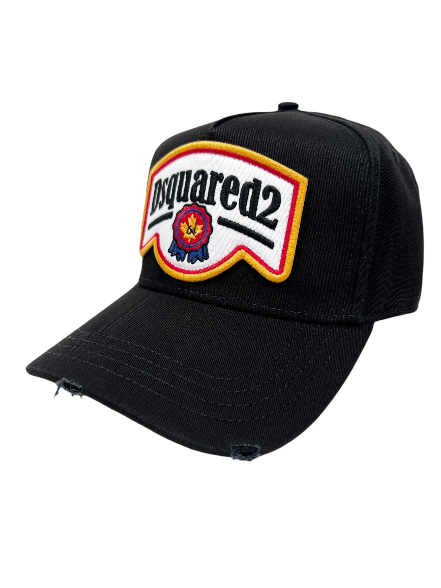 The DSQUARED2 BCM0847 Dsquared2 Logo Cap Nero is a black cap made from cotton gabardine. It features a front logo patch and distressed detailing for a stylish, worn-in appearance.