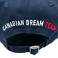 Close-up of a navy Dsquared2 BCM0917 gabardine baseball cap featuring "Canadian Dream Team" embroidered on the back in white and red. This DSQUARED2 hat has an adjustable buckle strap for a perfect fit.