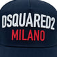 The DSQUARED2 BCM0917 Baseball Cap in navy features "DSQUARED2 MILANO" embroidered on the front in white and red letters, complete with an adjustable snapback for a perfect fit.