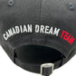 The Dsquared2 BCM0917 Baseball Cap Gabardine-Nero by DSQUARED2 showcases "CANADIAN DREAM TEAM" in bold white and red embroidery on premium cotton, offering an adjustable fit for ultimate comfort and style.
