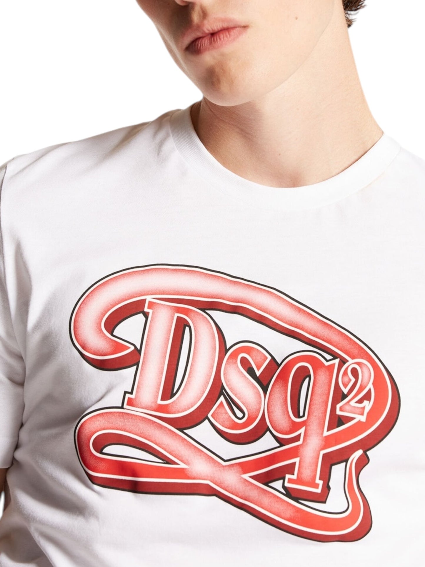 A person is wearing the Dsquared2 S71GD1387 Regular Fit Tee Wht, showcasing a striking red "DSQUARED2" logo. This fashionable T-shirt, crafted in Romania, is made from 100% cotton to provide both comfort and quality.