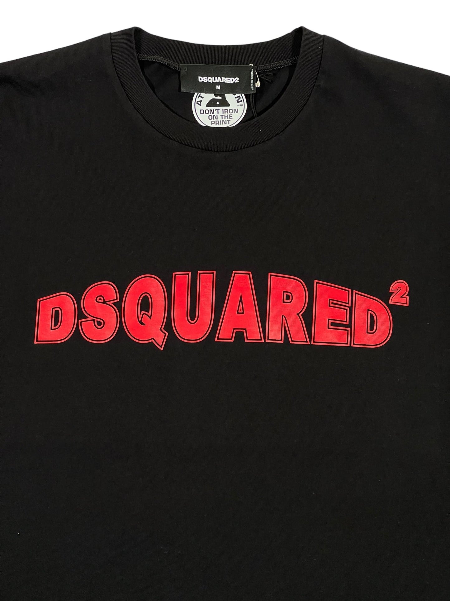 The DSQUARED2 S71GD1452 Cool Fit Tee in black features bold red "DSQUARED²" print on the front. Crafted from 100% cotton for superior comfort and durability, this piece is a perfect addition to any men's stylish clothing collection.