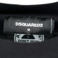 Close-up of a clothing label on a DSQUARED2 S74Gd1307 Cool Fit Tee Black in size "M," featuring the brand name "DSQUARED2." The care label below indicates it is made in Portugal and advises, "Don't Iron.