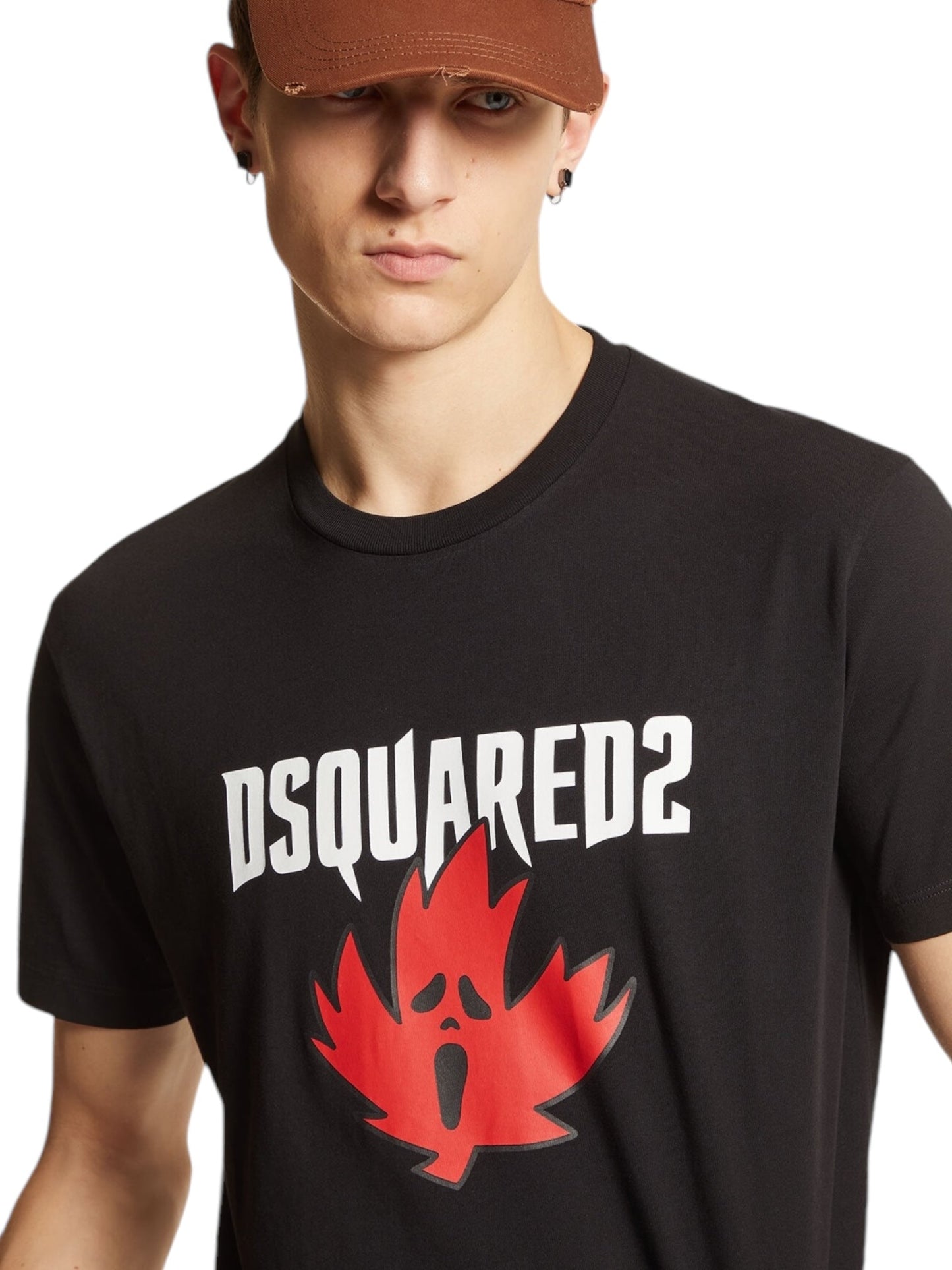 A person wearing a stylish black Dsquared2 S74Gd1307 Cool Fit Tee featuring a red maple leaf design, paired with a brown cap.