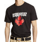 A person wearing a chic Dsquared2 S74Gd1307 Cool Fit Tee Black, styled with a bold red leaf graphic and made from 100% cotton, teamed up with beige pants and finished off with a DSQUARED2 belt.