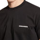 Wearing the effortlessly stylish Dsquared2 S74Gd1338 Cool Fit Tee Black, this individual highlights a quintessential piece of men's fashion with "DSQUARED2" prominently displayed across the chest.