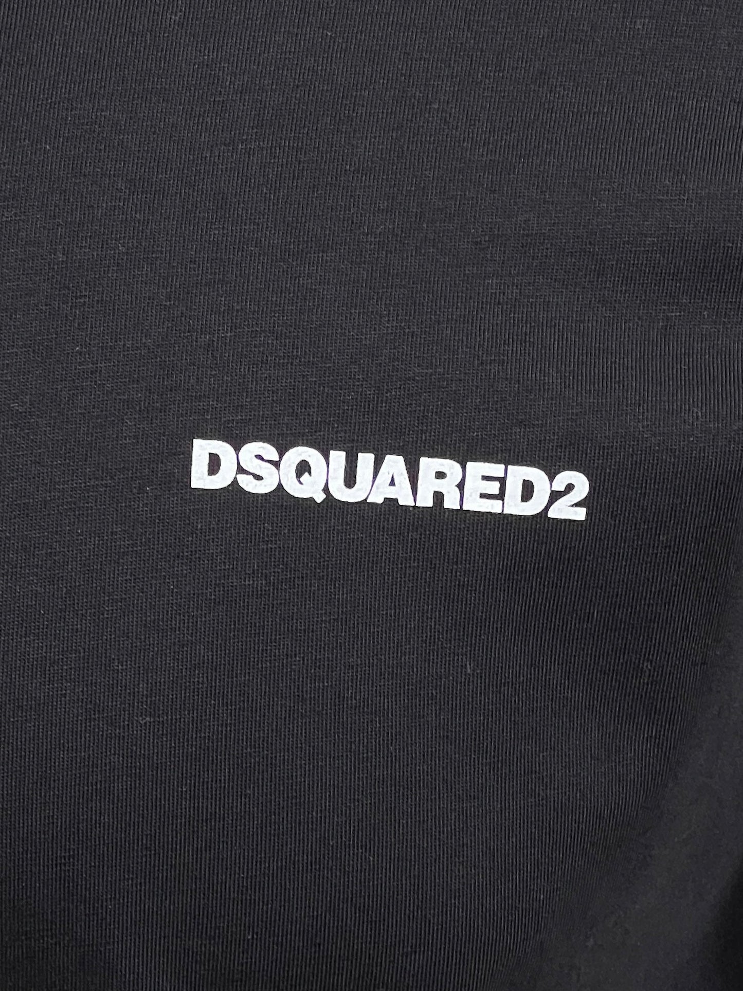 Close-up of the black Dsquared2 S74Gd1338 Cool Fit Tee, featuring the white text "DSQUARED2," showcasing a stylish choice.