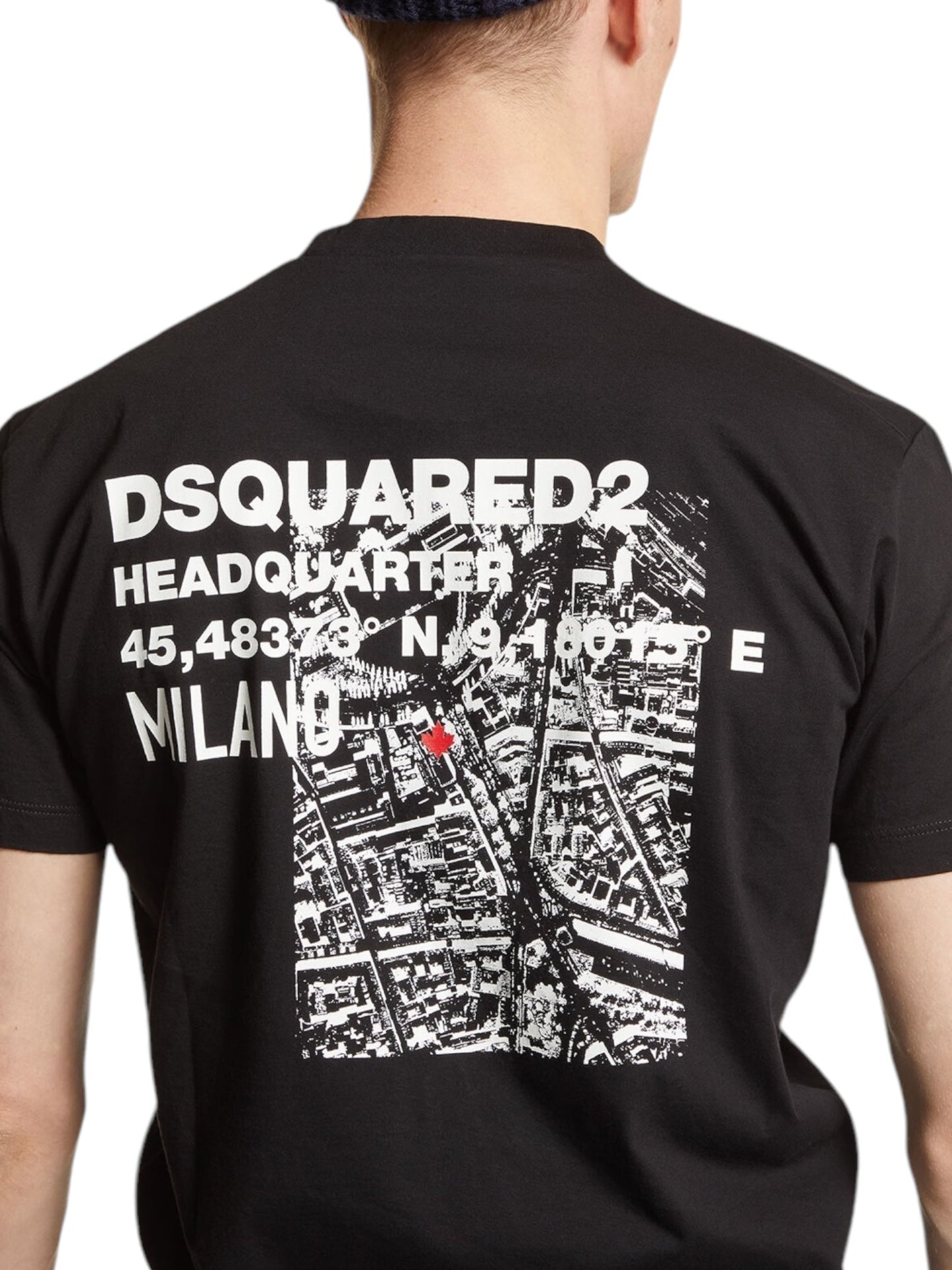 A person dons a Dsquared2 S74Gd1338 Cool Fit Tee Black from DSQUARED2, showcasing a sleek black design with a white map and the text "DSQUARED2 Headquarters" and "Milano" on the back, epitomizing modern men's fashion.