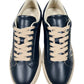 The Dsquared2 SNM0384 Cassetta Sneakers by DSQUARED2 feature a top-down view of navy blue shoes with cream laces and beige soles, crafted from premium leather, set against a white background.