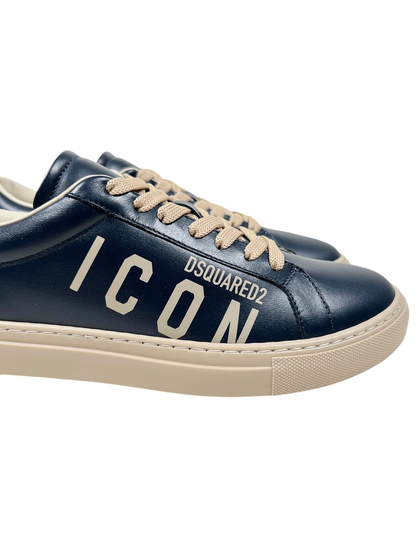 A pair of DSQUARED2 SNM0384 Cassetta Sneakers in navy with beige laces, crafted from premium leather and showcasing "ICON" prominently on the side.