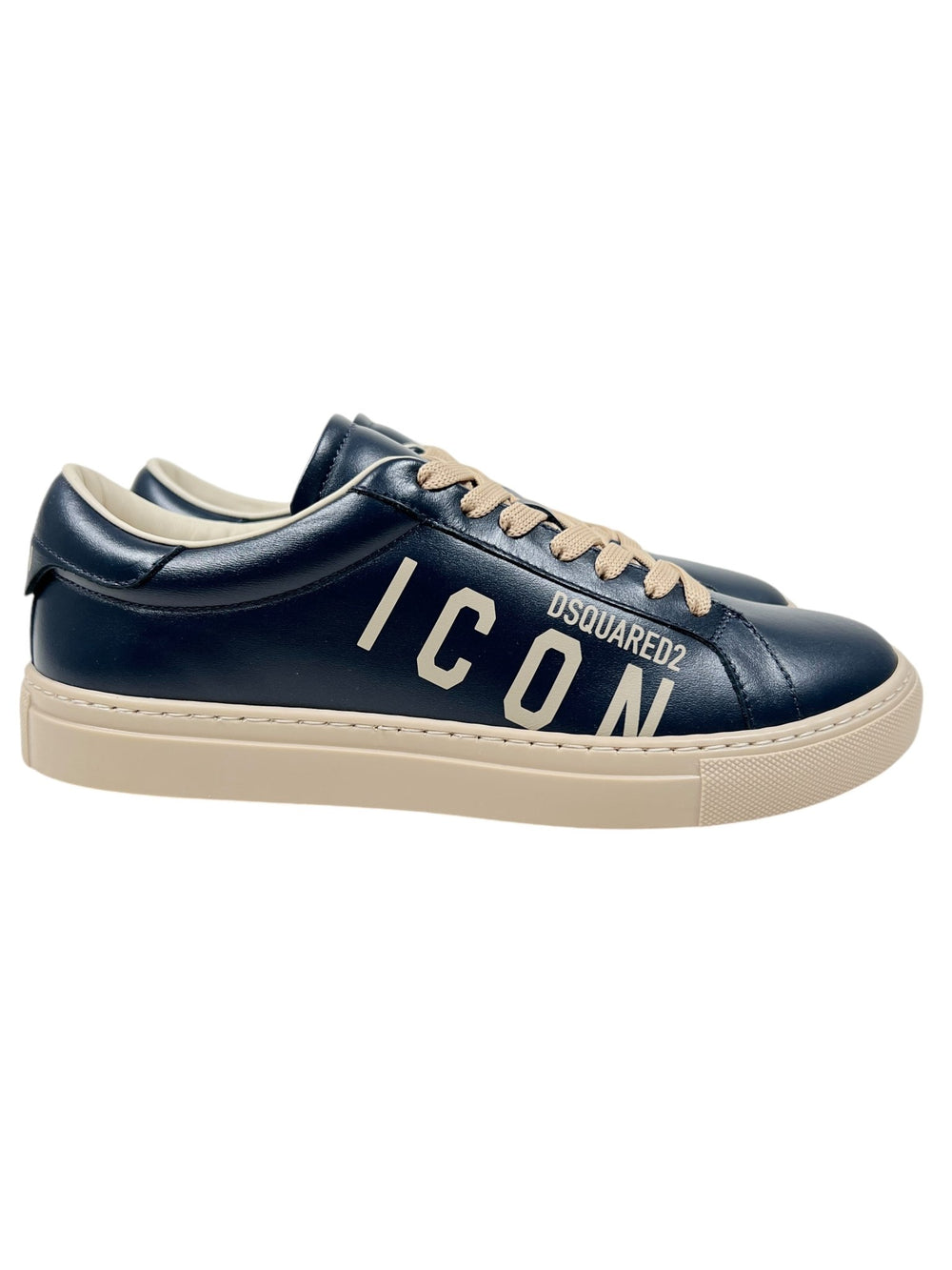 The Dsquared2 SNM0384 Cassetta Sneakers Nvy-Beige showcase dark blue premium leather, complemented by beige laces and soles, and are adorned with the "ICON DSQUARED2" text on the side.