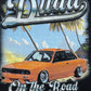 An illustration on the DUAA Duaa Destination Blk Tee Shirt shows an orange car with crystal details, palm trees, and a beach. "Duaa" and "On the Road" are in bold script above and below—perfect for your favorite black tee.