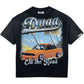 The DUAA Duaa Destination Blk Tee Shirt features "Duaa" and "On the Road" text with an orange sports car, palm trees, and a beach graphic—perfect for adding summer vibes to your casual style.