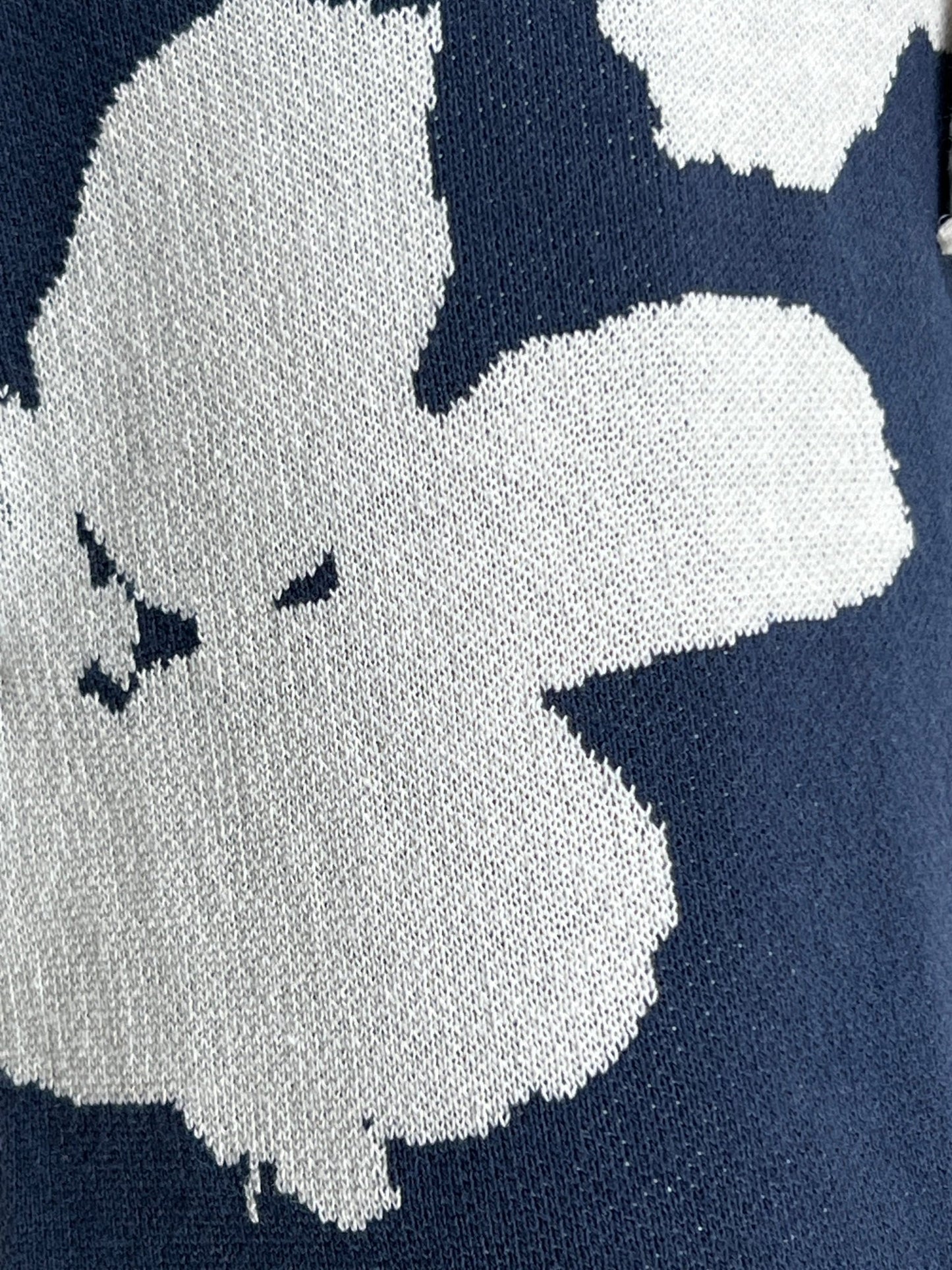 Close-up of a fabric with a knitted pattern featuring a grey and white cloud with an angry expression on a navy blue background, ideal for Family First JOSS2403 Jogger Short Jacquard DB.
