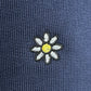 The Family First JOSS2503 Short Flower Dark Blue by FAMILY FIRST features a charming small embroidered white daisy with a yellow center on soft cotton navy blue shorts.