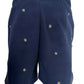 The FAMILY FIRST JOSS2503 Short Flower Dark Blue features an elastic waistband and is adorned with white and yellow daisy embroidery scattered on dark blue fabric.