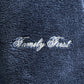 Close-up of the dark blue Family First JOSS2504 Jogger Short Track fabric with "Family First" embroidered in white cursive, ideal for jogging attire.