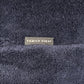 Close-up of textured dark blue jogger shorts labeled "FAMILY FIRST" in white text, from the Family First JOSS2504 collection.