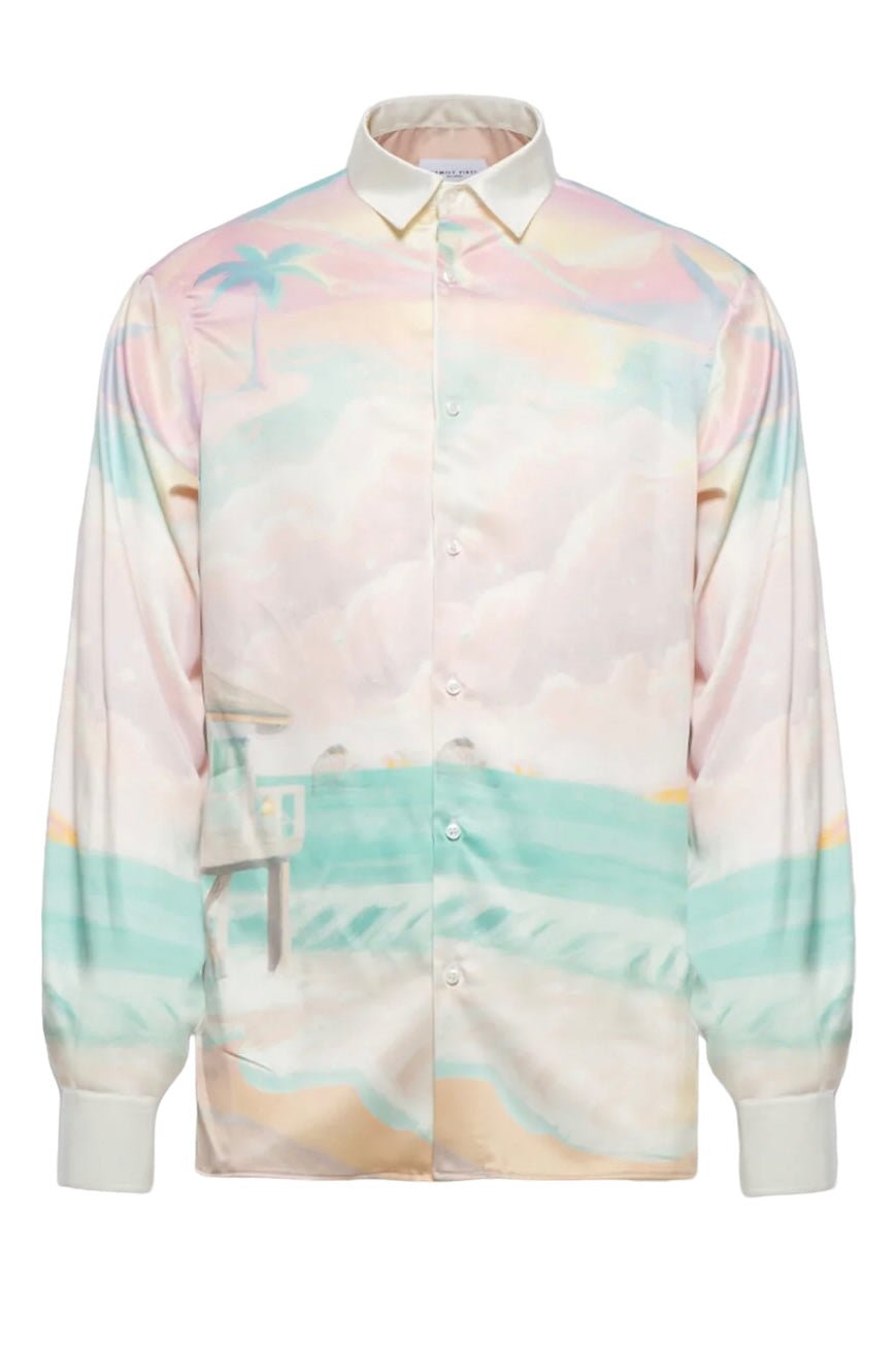 A FAMILY FIRST SHS2409 SHIRT DREAMS MC featuring a pastel beach scene with palm trees, ocean waves, and a lifeguard tower. The shirt has a white collar and cuffs, embodying FAMILY FIRST's signature style and proudly Made In Italy.