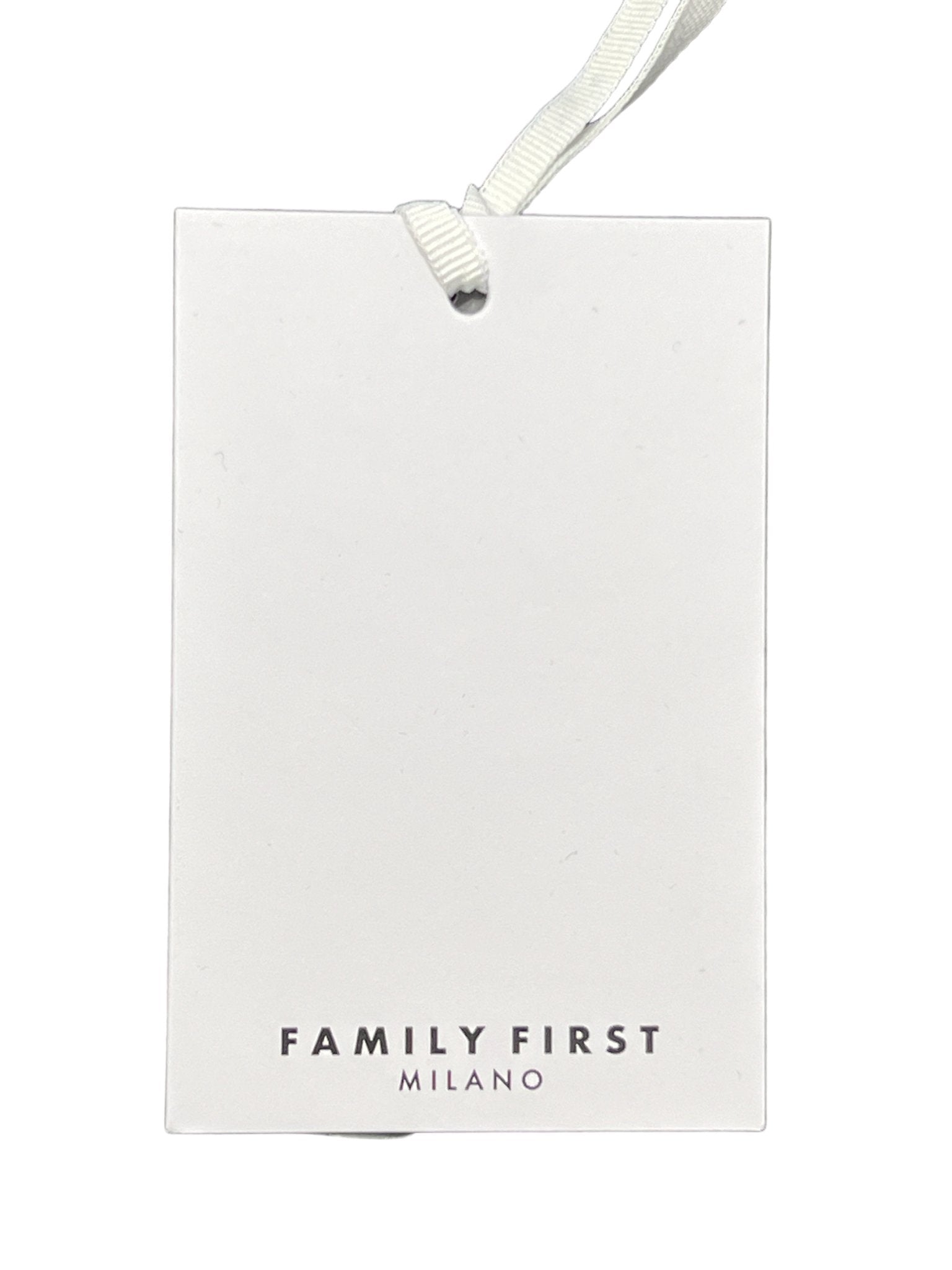 White rectangular tag with a white string at the top and the text "FAMILY FIRST MILANO" printed in black at the bottom, proudly showcasing the craftsmanship of "Made In Italy." Ideal for pairing with a chic FAMILY FIRST SHS2409 SHIRT DREAMS MC long sleeve shirt.