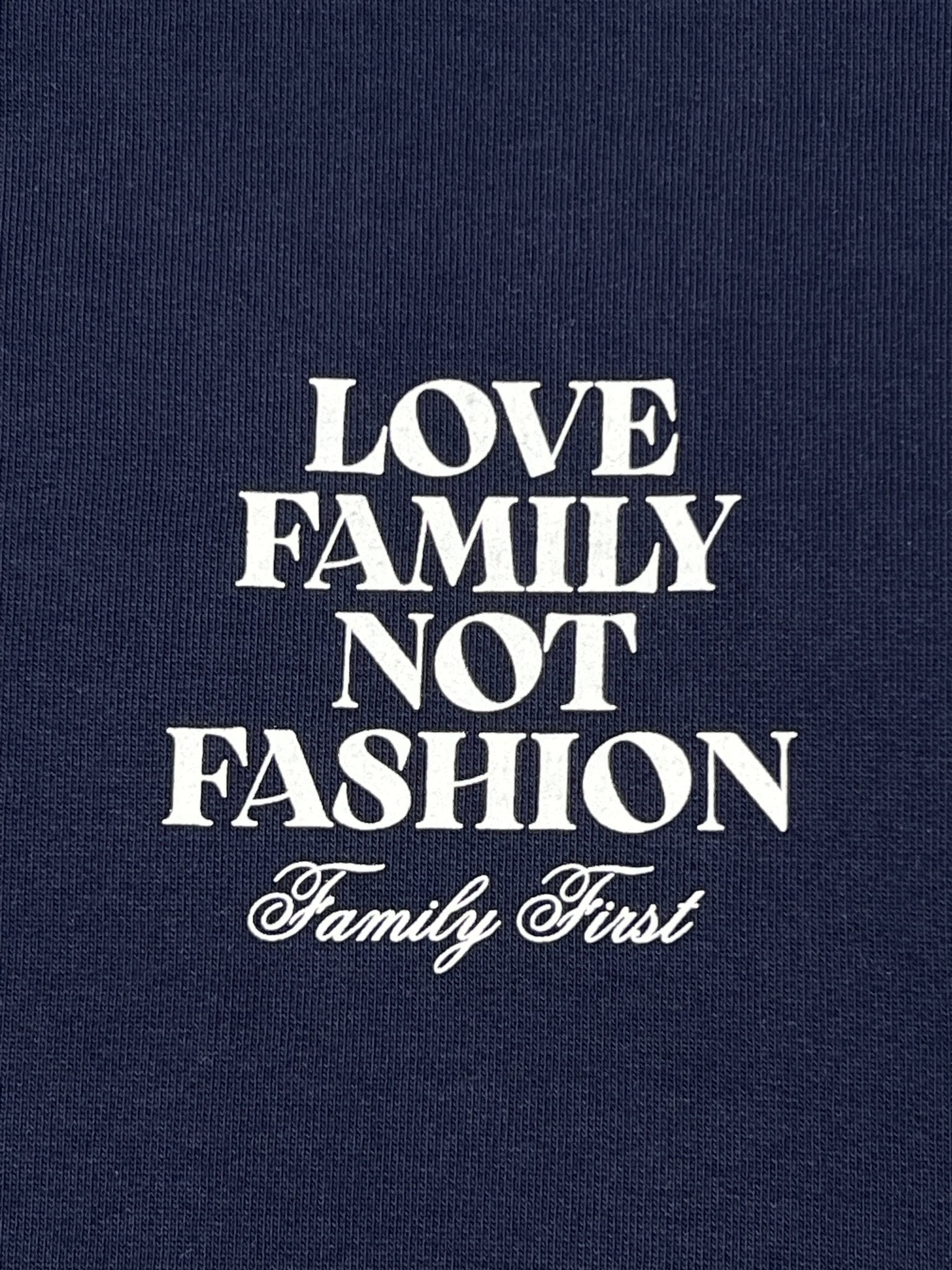 Featuring elegant embroidered flowers, the Family First SS2502 Sweat Flower Dark Blue sweatshirt from FAMILY FIRST highlights a navy background with white text: "Love Family Not Fashion. Family First," embodying the sentiment of valuing family over fleeting trends.