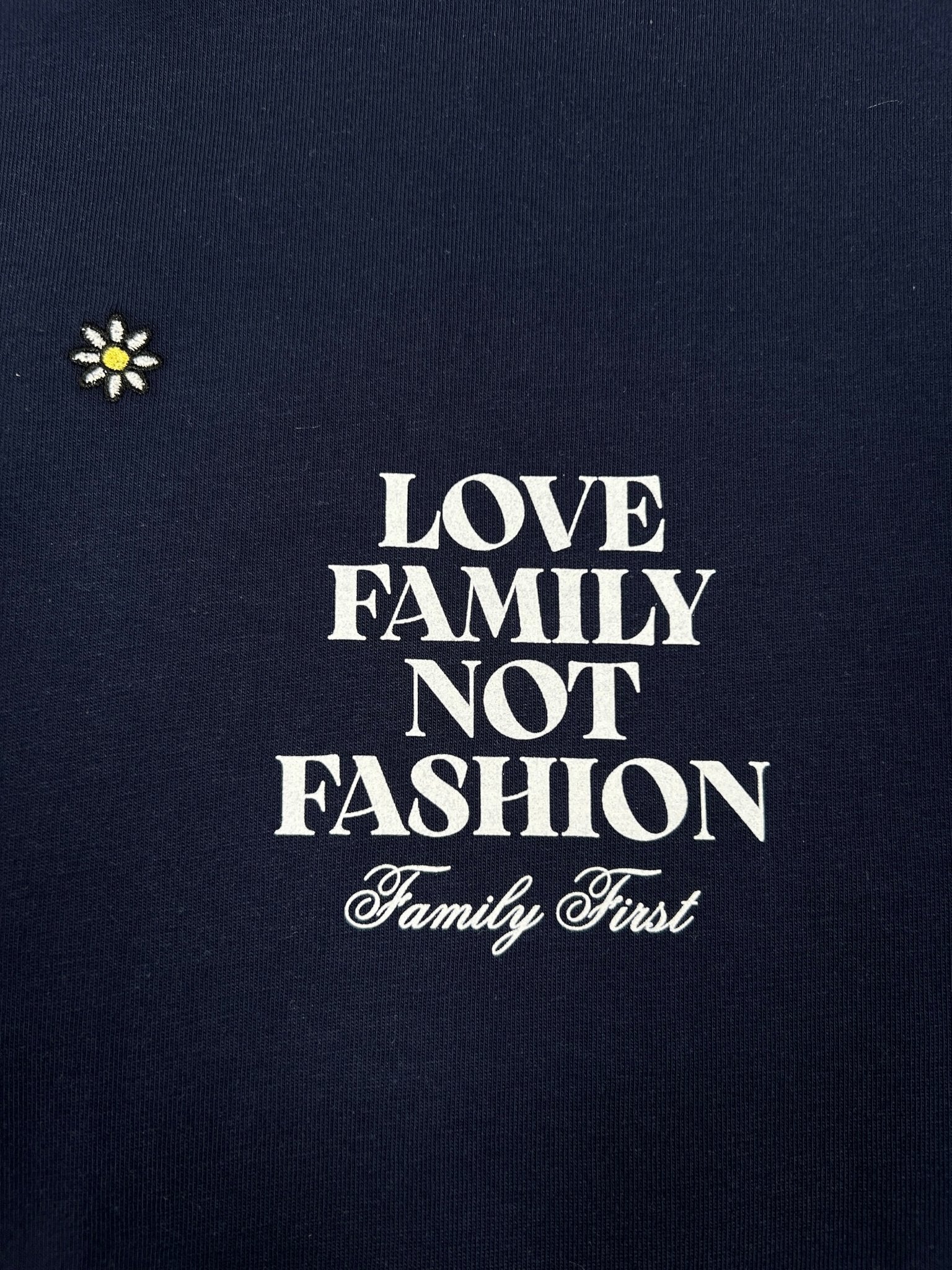 Dark blue Family First T2502DB T-shirt by FAMILY FIRST, featuring a phrase: "Love Family Not Fashion, Family First," with a small embroidered flower.