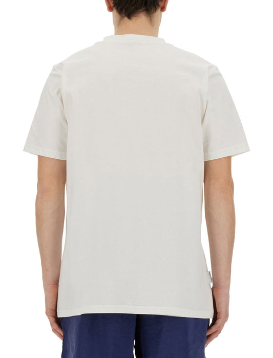 Rear view of a man wearing a FAMILY FIRST TS2404 T-shirt in Caviar white and navy blue pants.