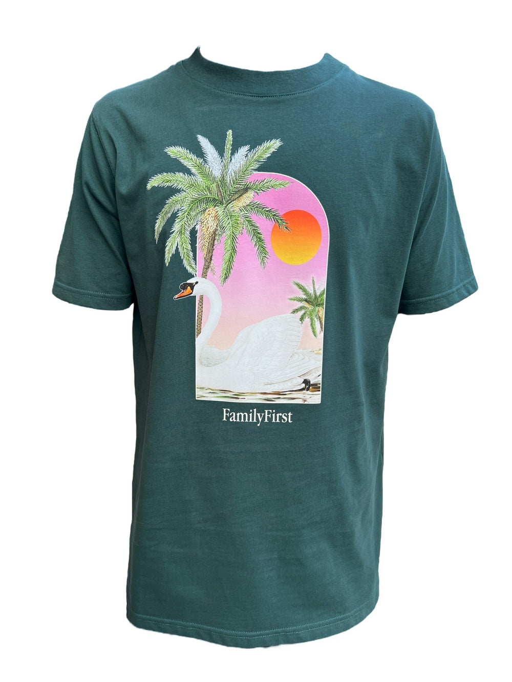 The FAMILY FIRST TS2407 T-SHIRT SWAN GR by FAMILY FIRST is a green short-sleeve graphic t-shirt featuring a printed design of a swan, palm trees, and a sunset, with "FAMILY FIRST" proudly displayed below the image.
