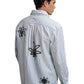 A man wears the Filling Pieces Dress Shirt Flowers Antique White by FILLING PIECES, featuring three black abstract floral monogram designs on the back, standing against a white background.