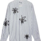 The Filling Pieces Dress Shirt Flowers Antique White by FILLING PIECES features long sleeves, blue vertical stripes, and black abstract floral monogram designs on the back.