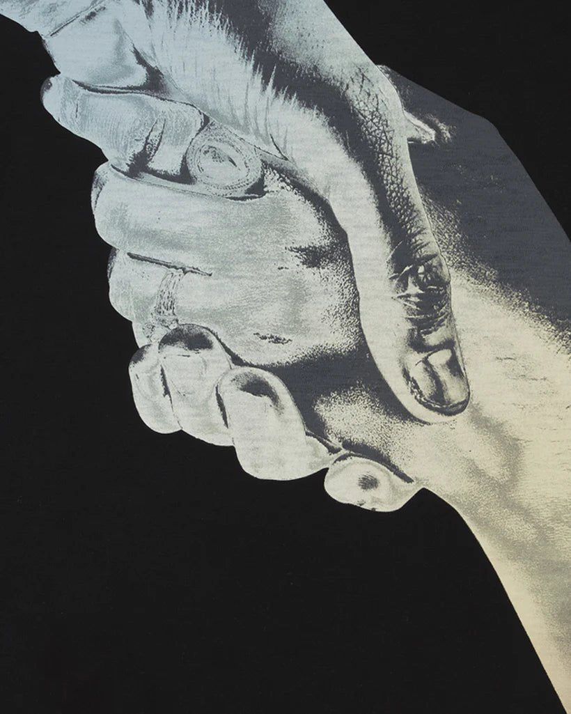 Black and white image of a close-up view of two hands clasped together in a firm handshake wearing the FILLING PIECES GRADIENT HANDSHAKE T-SHIRT BLACK.