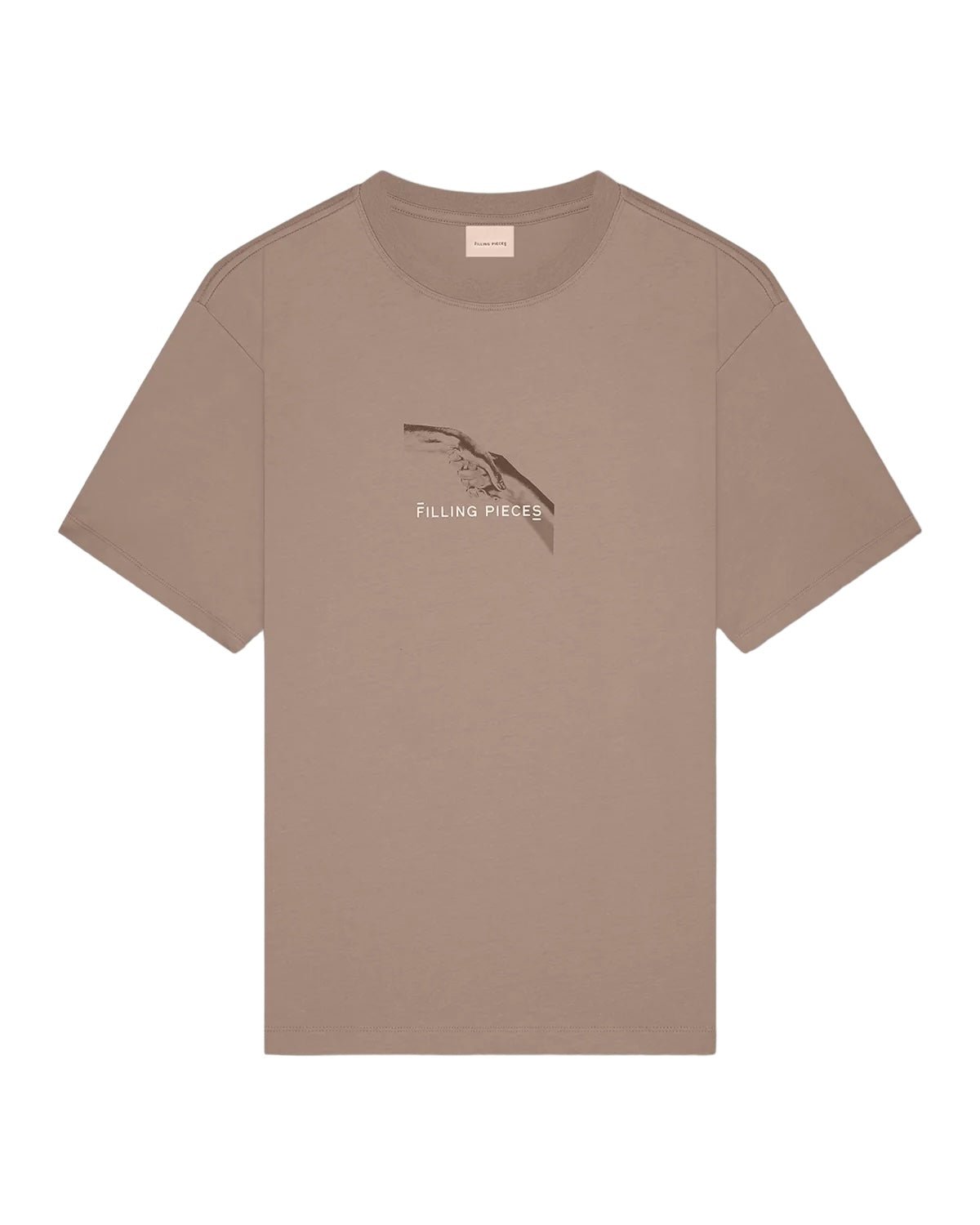 The FILLING PIECES HANDSHAKE FOSSIL T-SHIRT is a tan short-sleeve organic cotton T-shirt that features a printed design and the text "Filling Pieces" on the front, along with an FP handshake backprint.