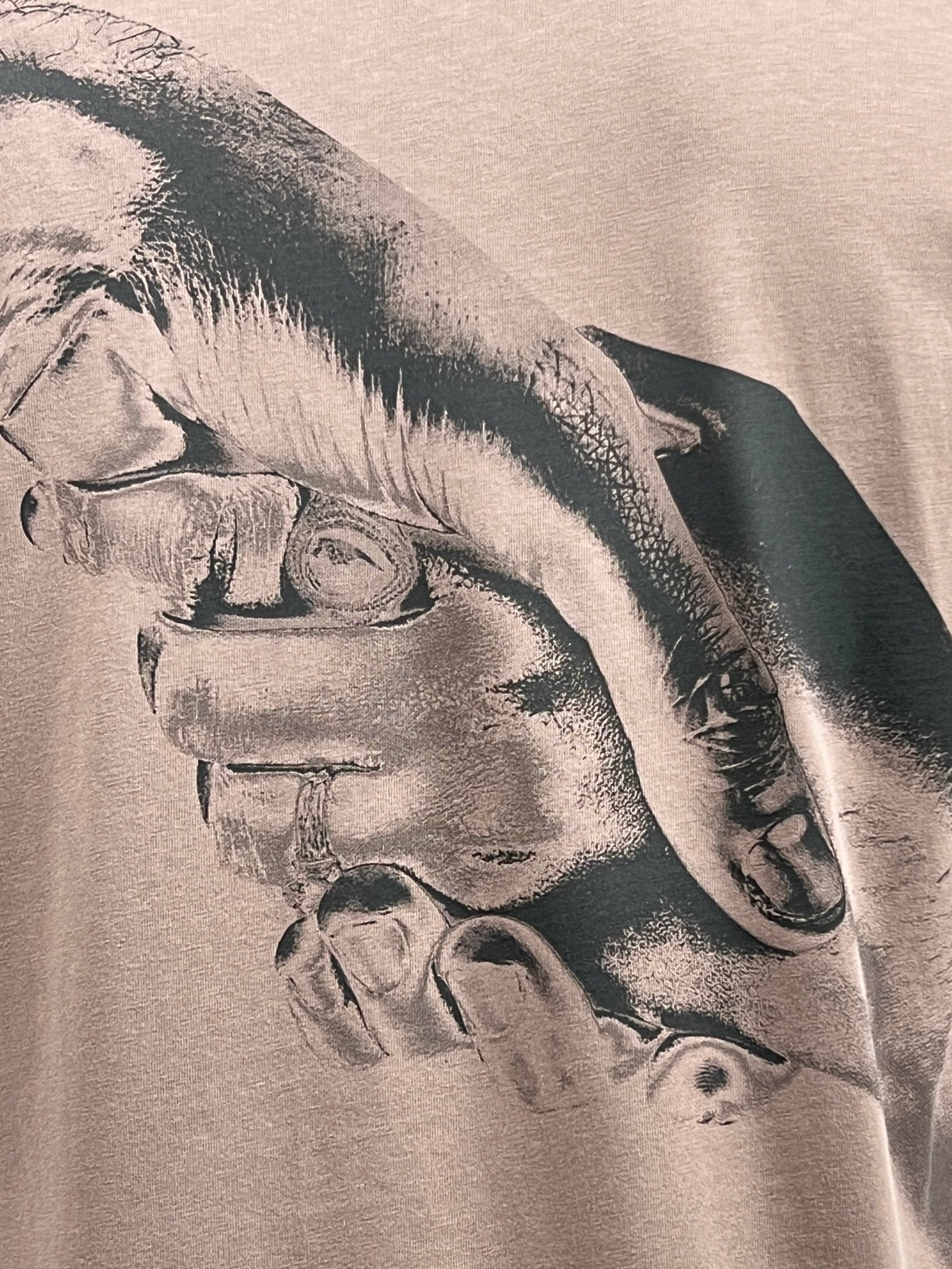 Close-up of an illustration on the FILLING PIECES HANDSHAKE FOSSIL T-SHIRT depicting two hands clasped together, suggestive of unity or support.