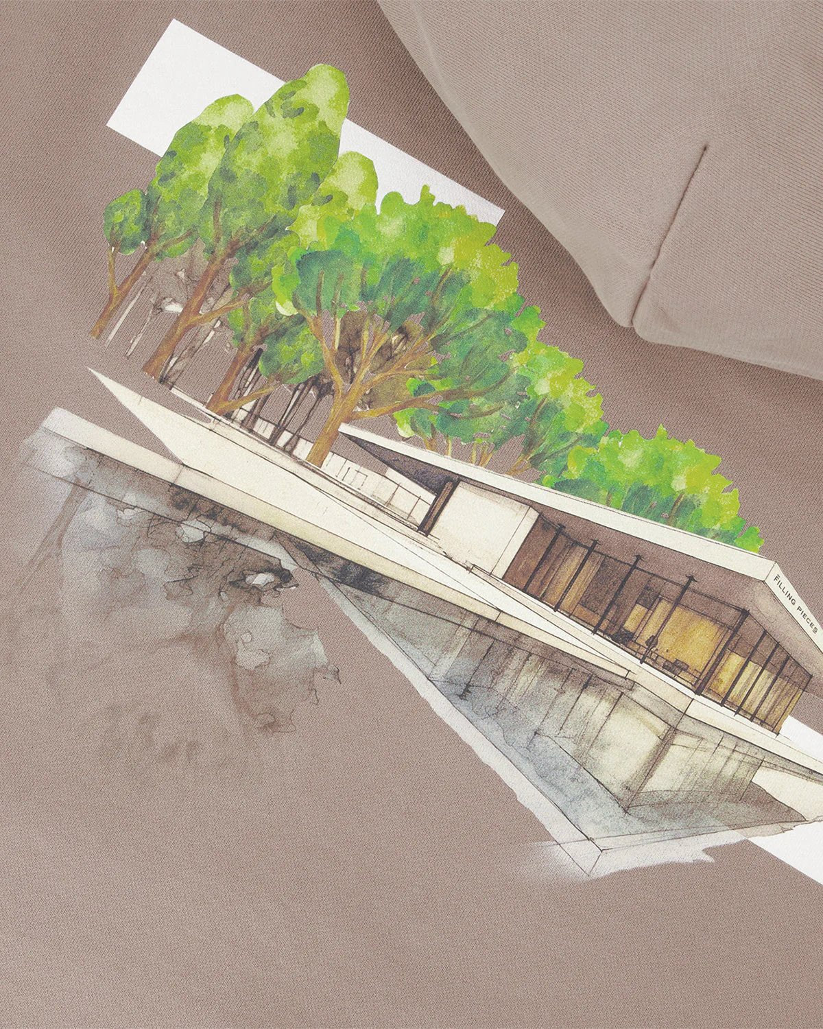 An image of a modern, minimalist building with large windows, trees, and water reflections on beige evokes a serene Pavilion scene, perfect for the back print of the FILLING PIECES organic cotton Hoodie Pavilion Fossil.