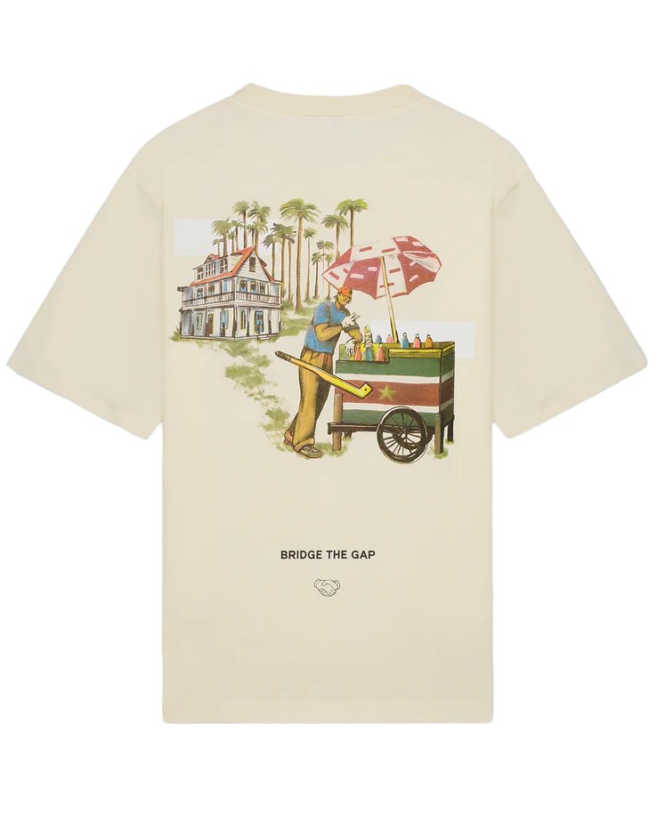 Beige Filling Pieces Ice Vendor Antique White t-shirt featuring a vintage-style illustration of a man pushing a fruit cart under palm trees, with the text "bridge the gap" at the bottom.