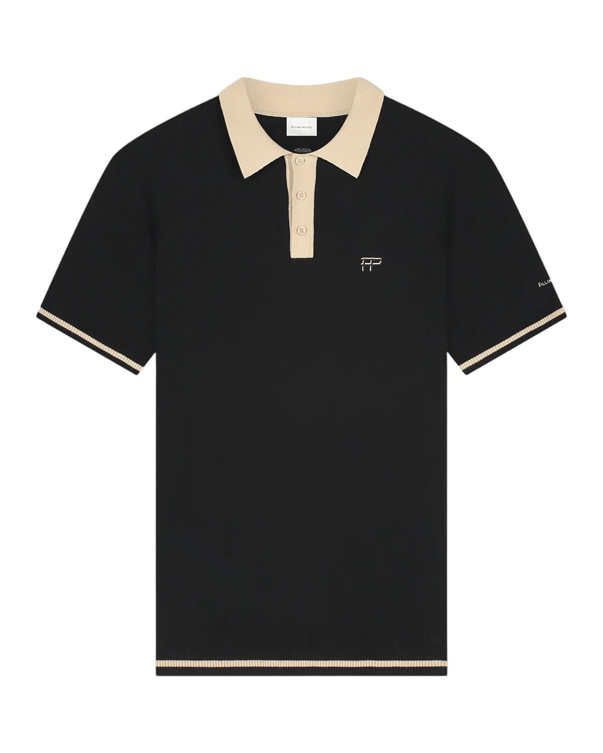 The FILLING PIECES KNIT POLO BLACK is a stylish black short-sleeve knit polo shirt featuring a beige collar and sleeve trim. It includes a buttoned placket with FP branded buttons and has a small embroidered logo on the chest. Made from 100% cotton, this polo ensures maximum comfort.