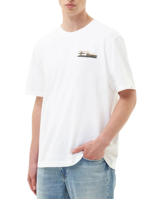 Person wearing a FILLING PIECES PAVILION WHITE T-SHIRT with an FP chest logo, paired with light blue jeans.