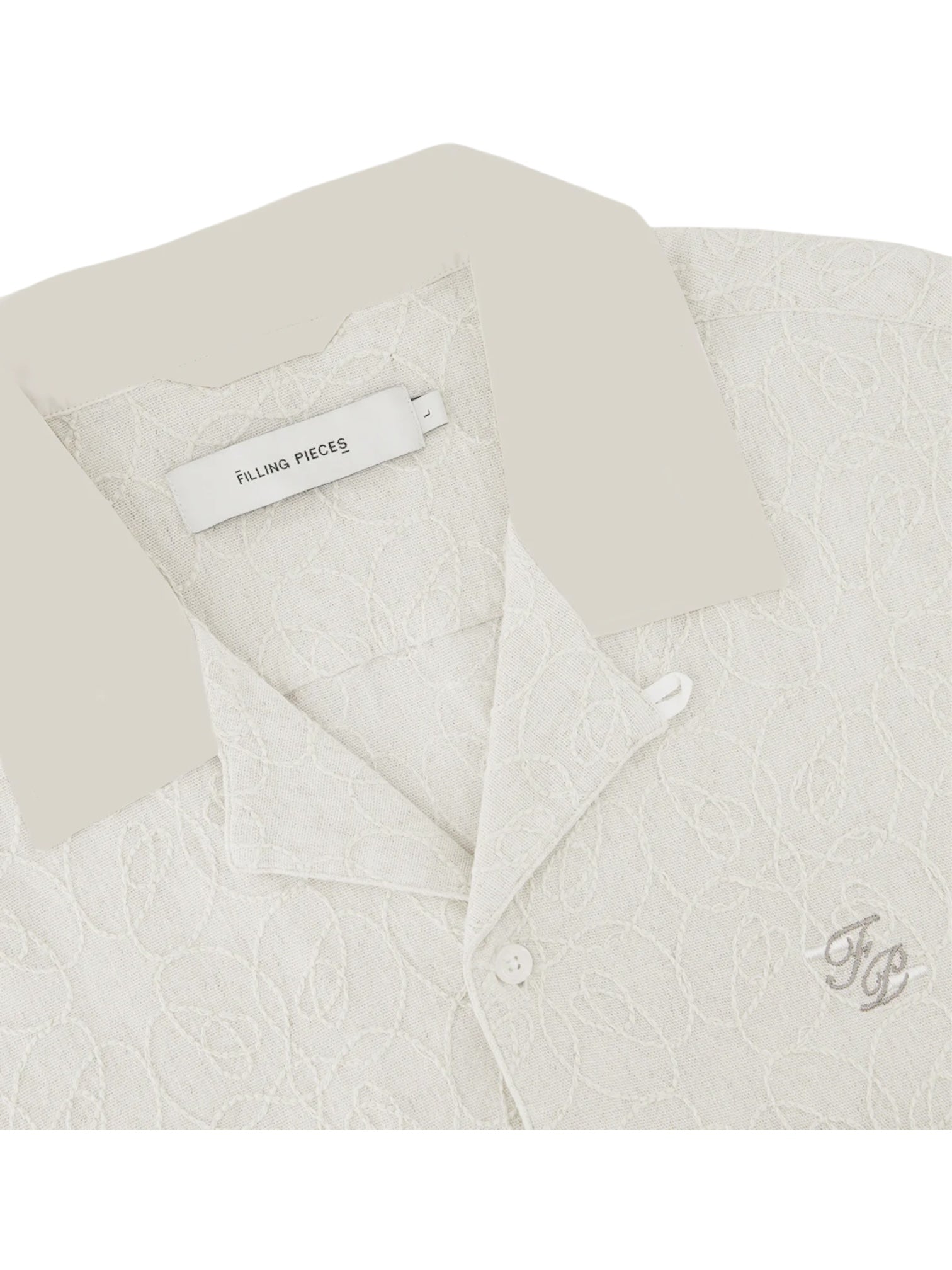 Close-up of the Filling Pieces Resort Shirt Petal by FILLING PIECES, featuring a light linen-viscose blend, textured pattern, "Filling Pieces" label, and an embroidered "FP" monogram on the chest.