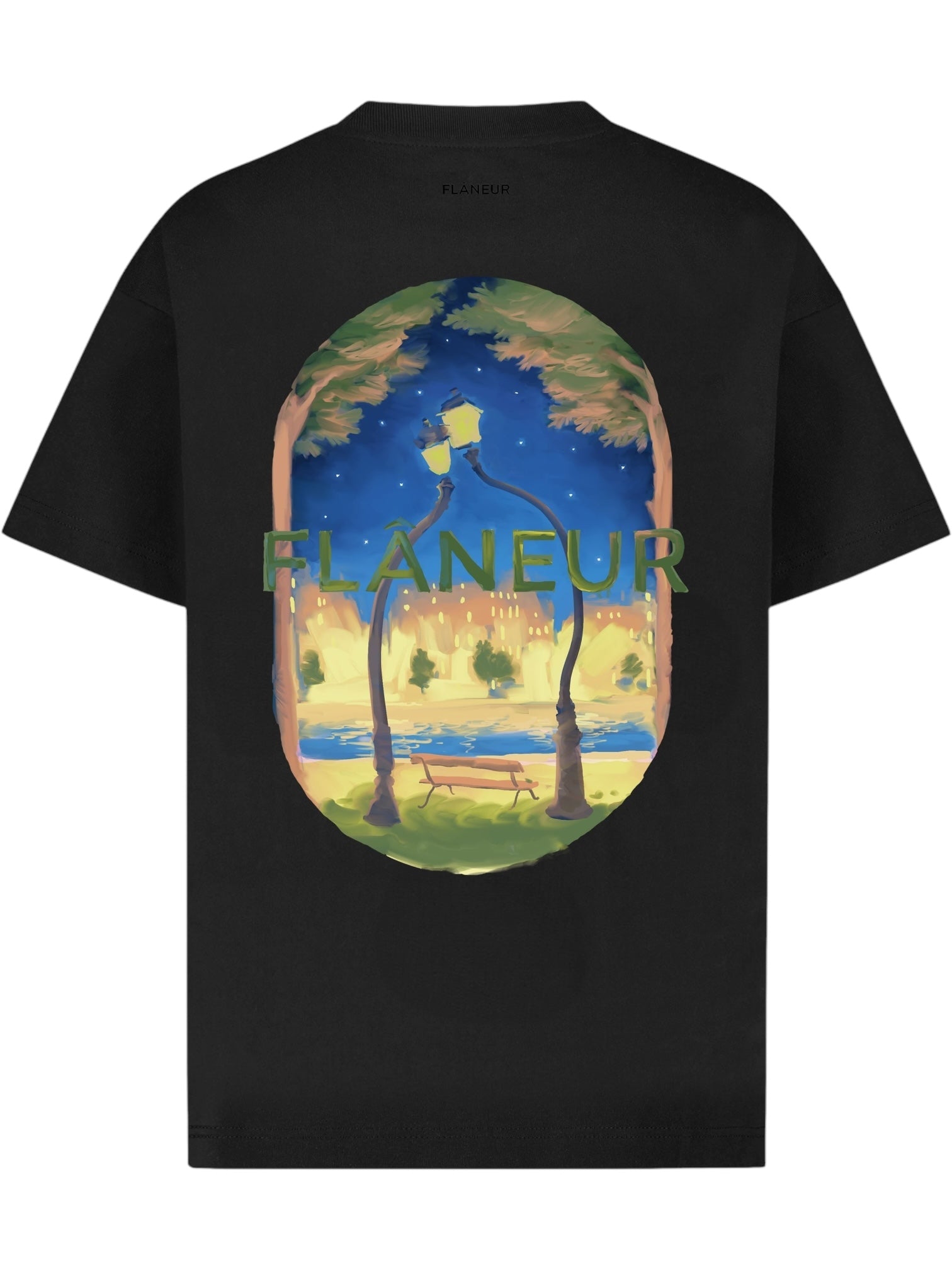 The FLANEUR Lanterns of Love T-Shirt Black is a soft cotton tee with an illustrated night scene—trees, a lamp post, deer—and “FLÂNEUR” printed across the back.