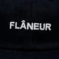 Check out the Flaneur Logo Cap Black by FLANEUR, featuring "FLÂNEUR" beautifully embroidered in white on the front. Made from premium cotton, it blends style and comfort perfectly for today's wanderer.