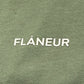 The Flaneur Logo T-Shirt Khaki by FLANEUR features "FLÂNEUR" in bold white caps on textured khaki cotton for a stylish, modern look.